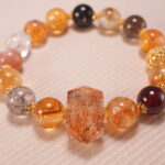 Close-up of faceted citrine beads and smooth gemstone texture