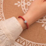 Model wearing cinnabar bracelet – bold red tones enhancing wrist style