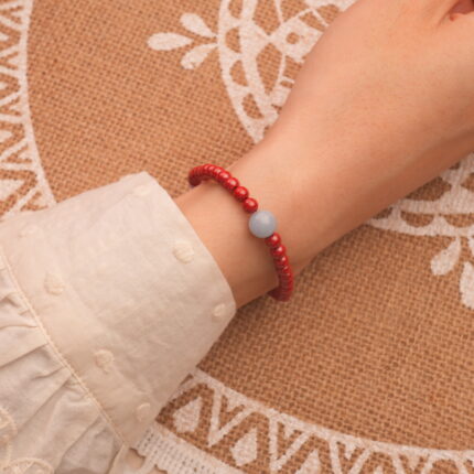 Model wearing cinnabar bracelet – bold red tones enhancing wrist style