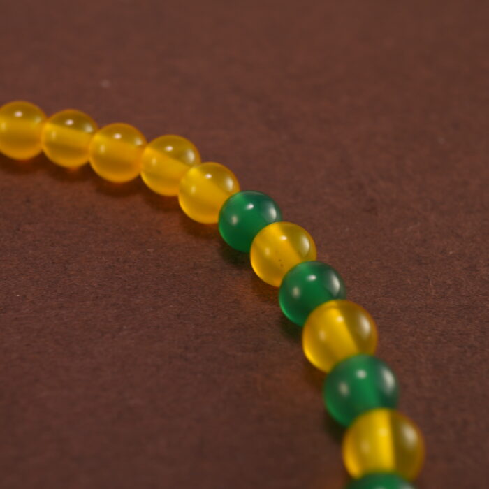 Close-up of cinnabar floral beads and vibrant agate stones