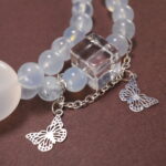 Close-up of Aquamarine Beads, Kyanite Stones, and Delicate Charms – Moon and Butterfly Design