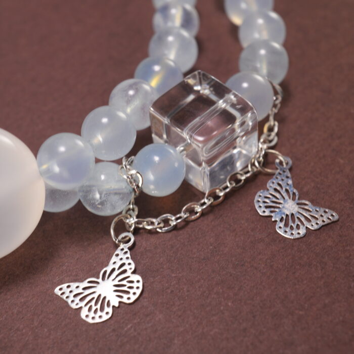 Close-up of Aquamarine Beads, Kyanite Stones, and Delicate Charms – Moon and Butterfly Design