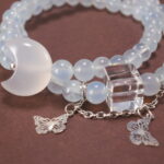 Close-up of Aquamarine Beads, Kyanite Stones, and Delicate Charms – Moon and Butterfly Design