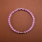 4mm amethyst beads on a simple background, showcasing their soothing lavender hue.