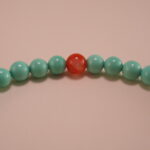 Close-up of turquoise, agate beads, and heart charm