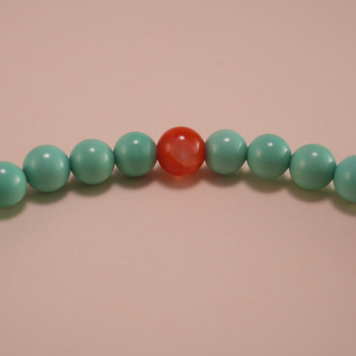 Close-up of turquoise, agate beads, and heart charm