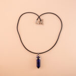 Handmade natural lapis lazuli point pendant on neutral or dark background