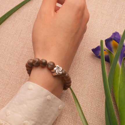 Bracelet worn on wrist, styled with cozy neutral outfit, showcasing natural texture