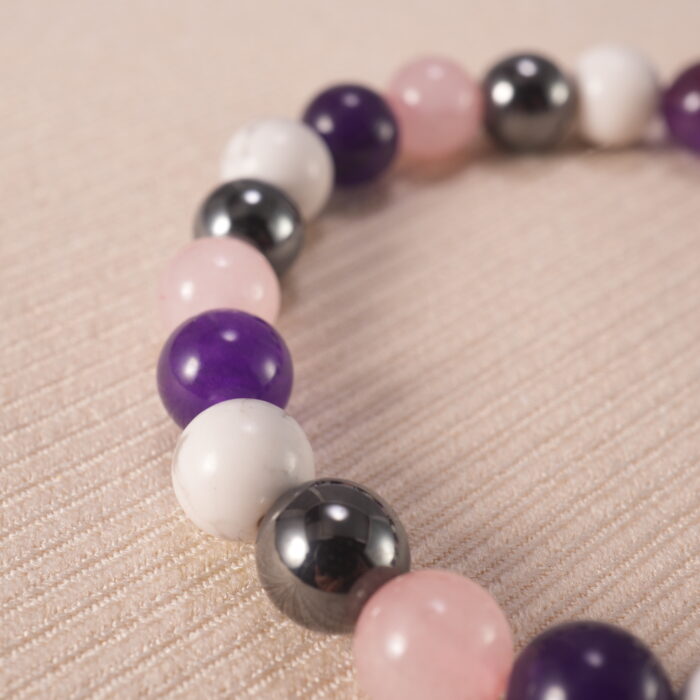 Close-up of 8mm obsidian, amethyst, and howlite beads, showing natural texture and polish.