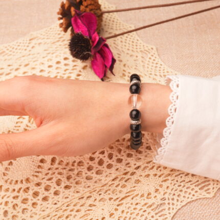 Obsidian & quartz bracelet worn on wrist with a minimalist outfit