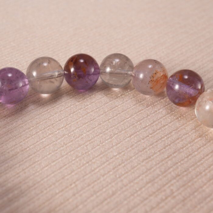 Detailed view of phantom amethyst textures and silver flower accent
