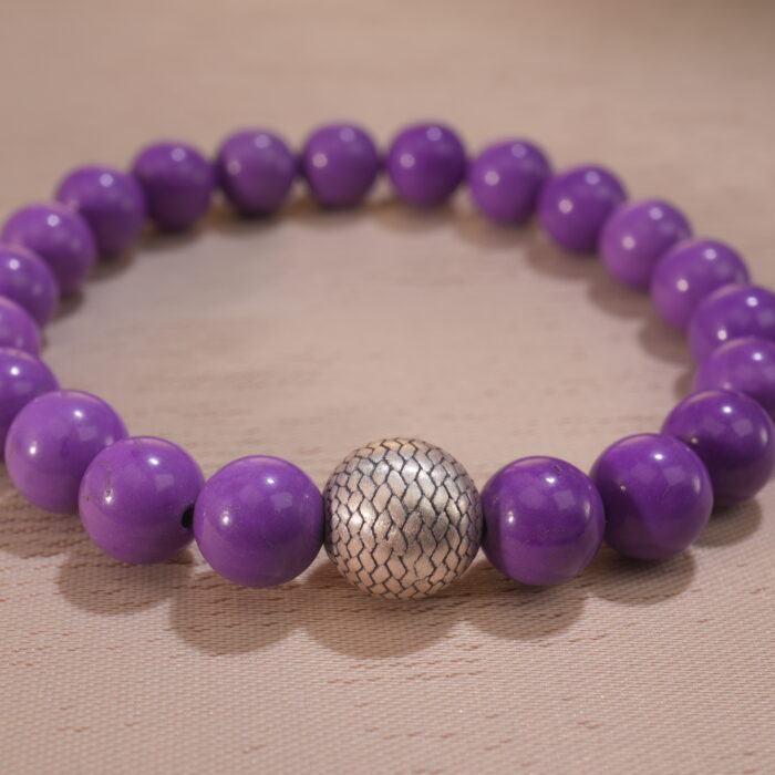 Close-up showing the soft lavender hue and natural patterns of each Phosphosiderite bead