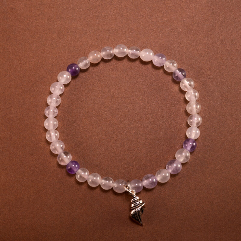 A 4mm Amethyst beaded bracelet with S925 charm arranged neatly on a minimal light background