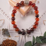 Heart bracelet styled with soft floral props for a romantic, energizing look