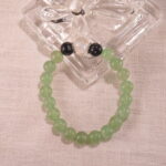 Bracelet placed on soft linen with natural stones