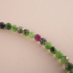 Close-up of Ruby Zoisite stones in round polished beads