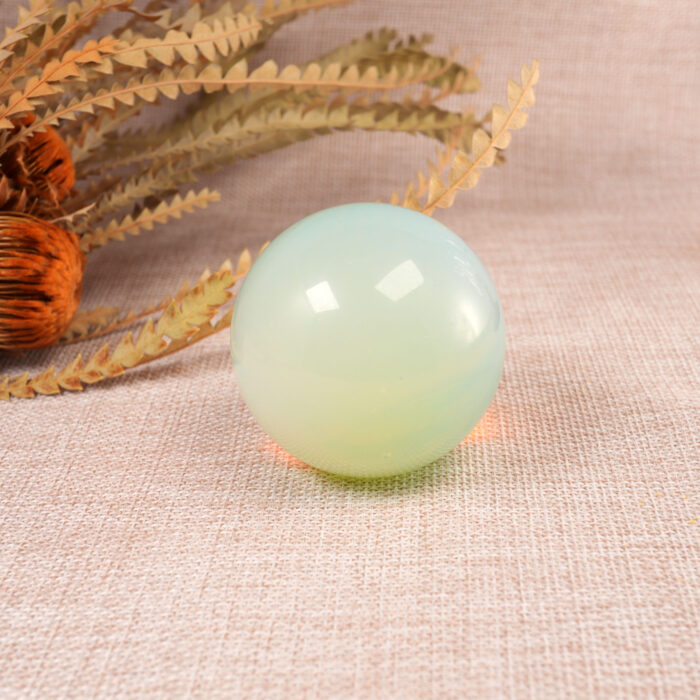 Close-up of the opal sphere showing iridescent colors and surface details