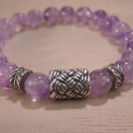 Close-up of second amethyst bracelet showing bead shape and deep hue.