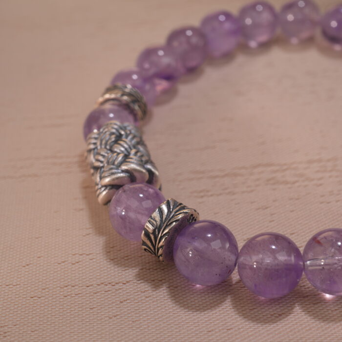 Close-up of second amethyst bracelet showing bead shape and deep hue.