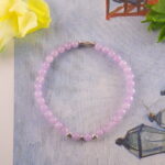 Amethyst bracelet in daylight with deep violet tone.