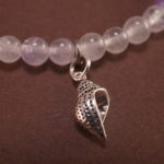Close-up of amethyst and white chalcedony bracelet with silver.