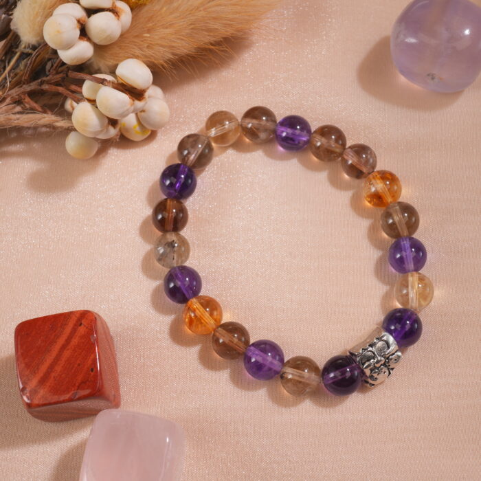 Ametrine bracelet placed in natural light on minimal textured surface.