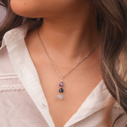 Model wearing Aquarius zodiac necklace with amethyst, blue apatite, and aquamarine.