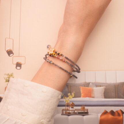 Model showcasing the piece wrapped around the wrist as a layered bracelet.