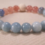 Close-up of blue chalcedony bracelet with strawberry quartz and lava.
