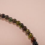 Close-up of dark tourmaline bracelet with silver.
