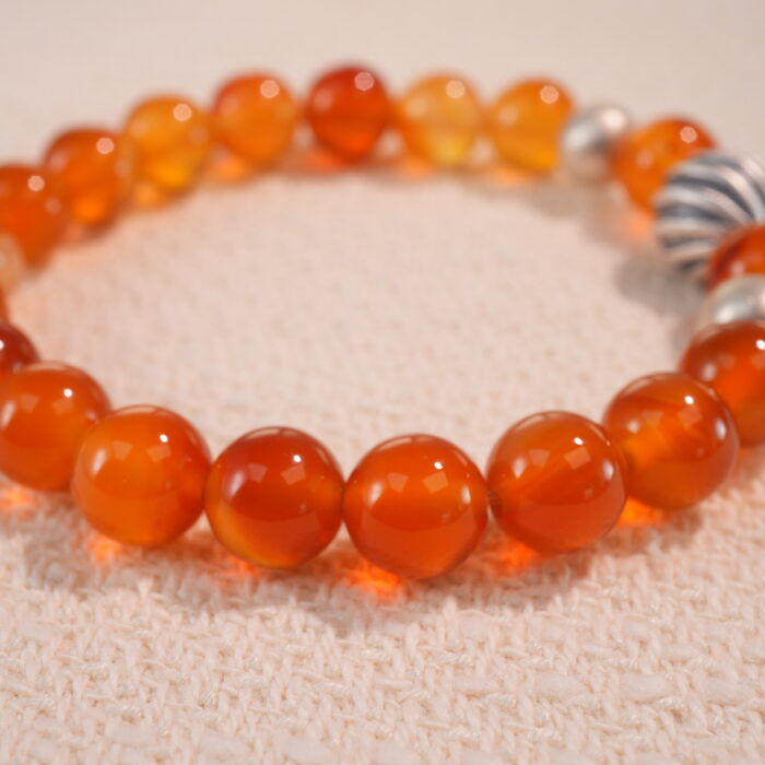 Close-up of second flower red agate bracelet with slightly varied tone.