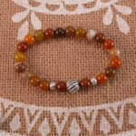 Flower red agate bracelet in daylight showing layered color.