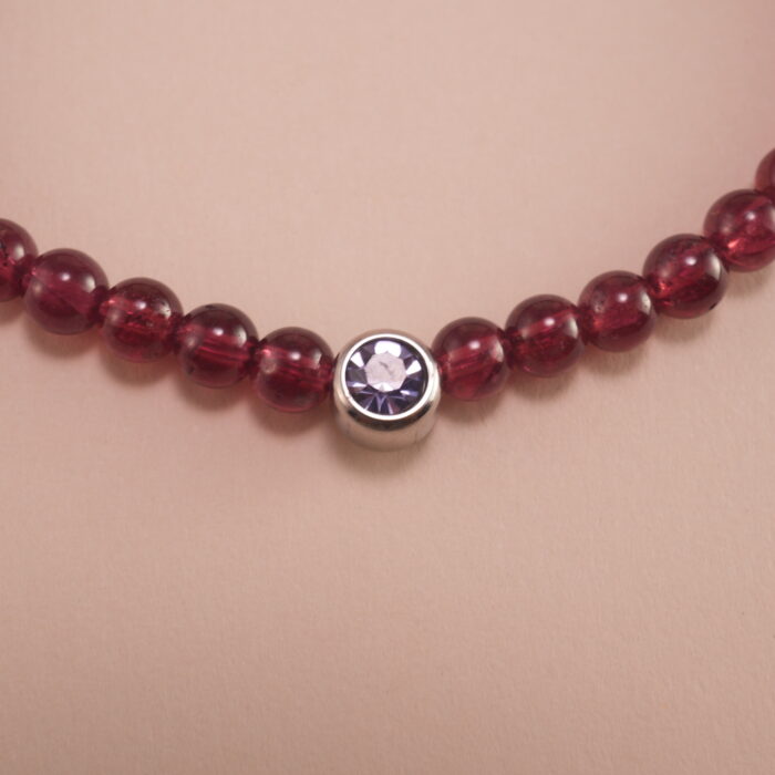 Close-up of garnet bracelet with deep red beads.