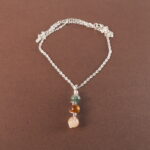 Gemini zodiac necklace with moss agate, tiger eye, and citrine gemstones.