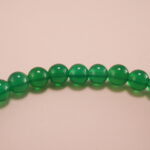 Close-up of green chalcedony bracelet with smooth finish.