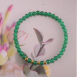 Bracelet in soft daylight showing fresh green tone.