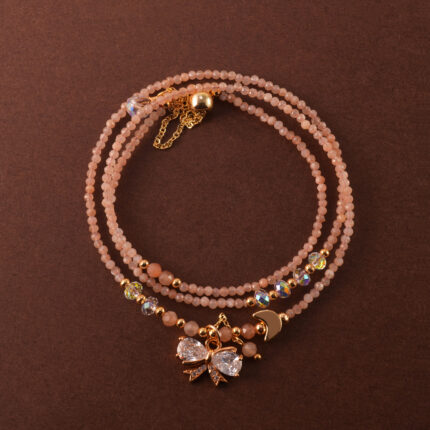 Handmade rose quartz necklace that can also be worn as a three-wrap bracelet, shown coiled elegantly.