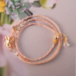 Full view of the rose quartz necklace laid flat, showing bead size and arrangement for versatile wear.