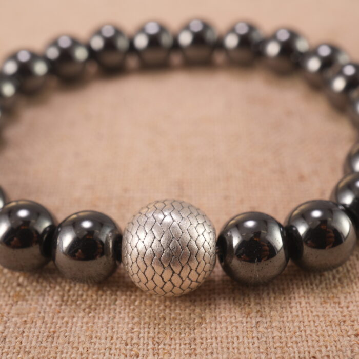 Close-up of hematite bracelet with S925 silver accents and metallic shine.