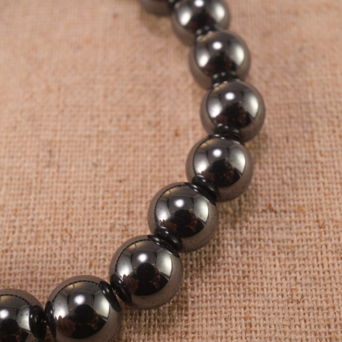 Close-up of hematite bracelet with S925 silver accents and metallic shine.