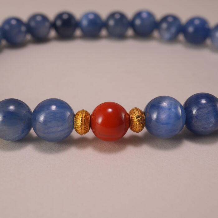 Close-up of kyanite and red agate bracelet.