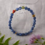 Bracelet in natural light with bold blue and red tones.