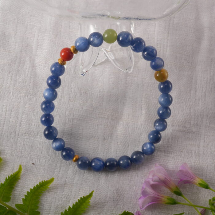 Bracelet in natural light with bold blue and red tones.