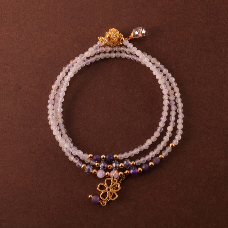 Multi-use necklace made with lavender and Uruguayan amethyst beads, shown coiled in a soft, elegant layout.