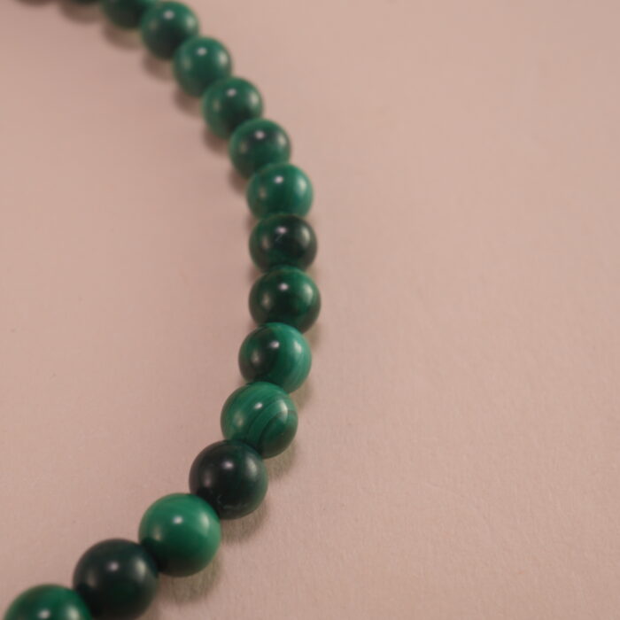 Close-up of malachite and amethyst bracelet.