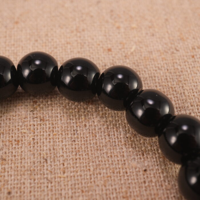 Close-up of obsidian bracelet with S925 silver spacer beads.