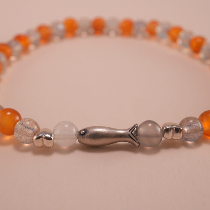 Close-up of orange chalcedony and gray moonstone bracelet with silver.