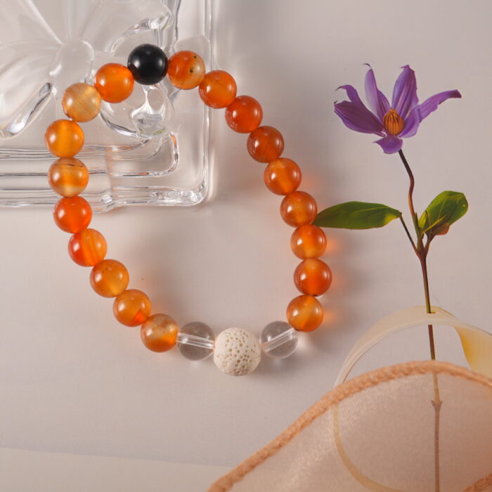 Bracelet in daylight showing vibrant agate and lava contrast.
