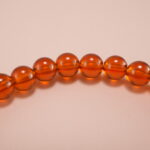 Close-up of orange-red garnet bracelet with silver.