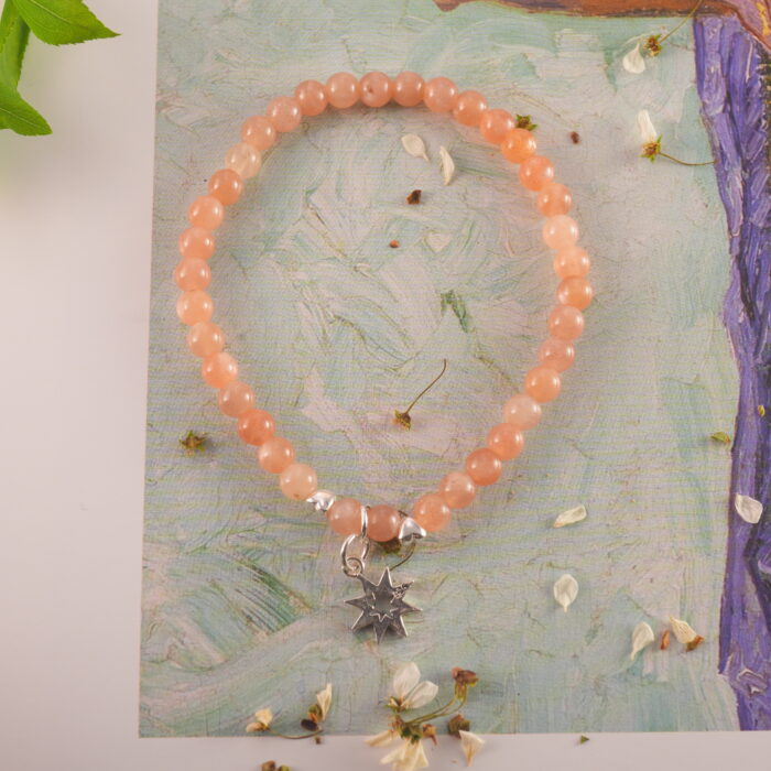 Bracelet in natural light showing soft peach glow.